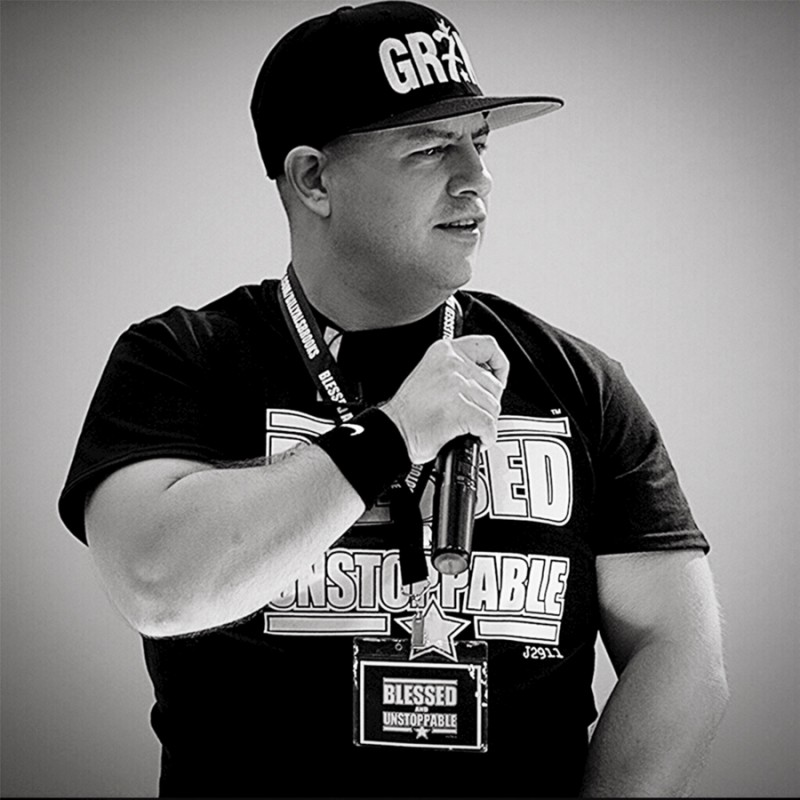 Dr. Billy Alsbrooks holding a microphone while doing a show.